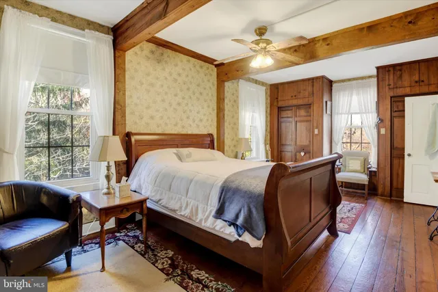 a bed room with a bed and a chair