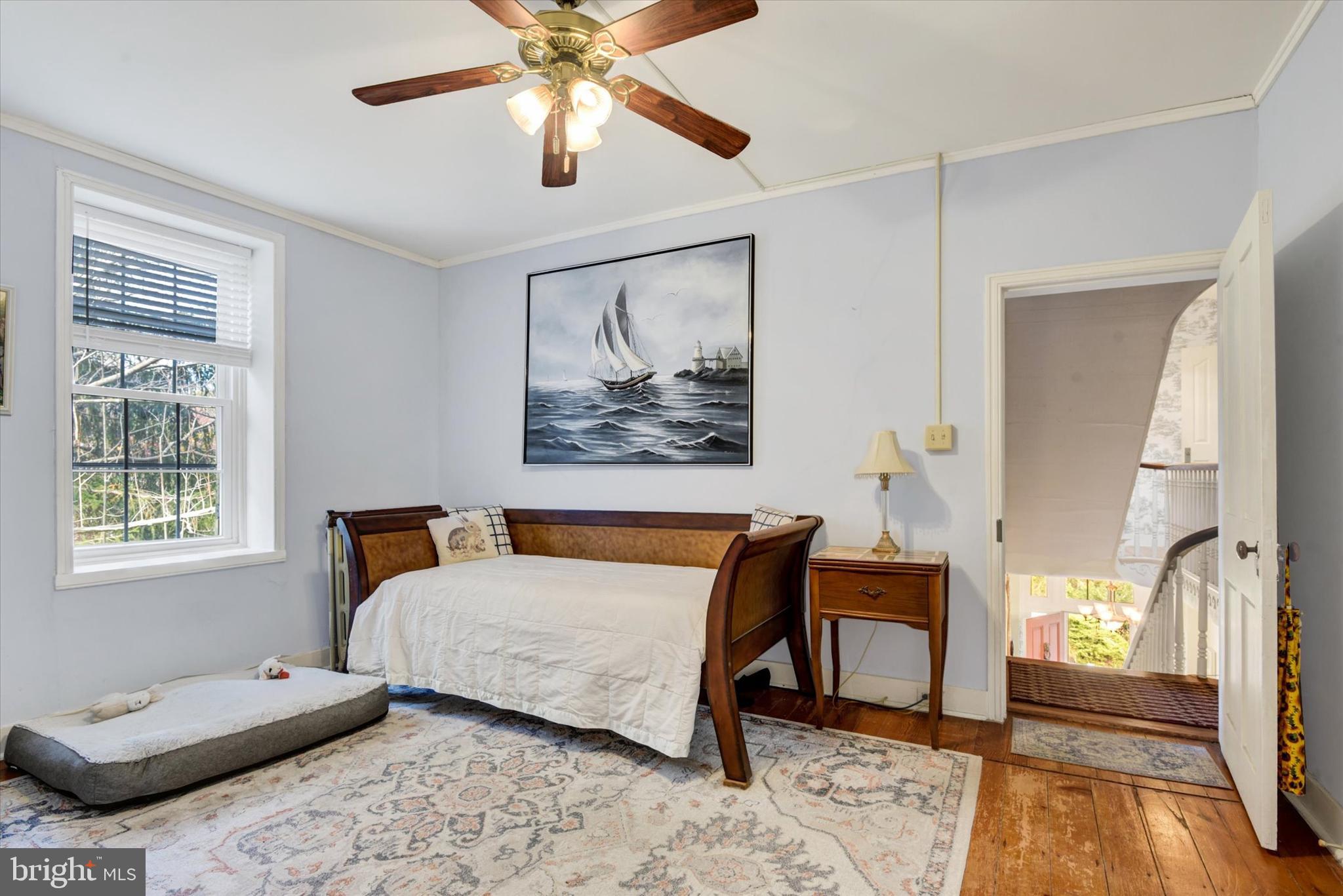 6739 South Clifton Road Frederick, MD 21703 - Photo 31 of 49 a bedroom with a bed and a chandelier