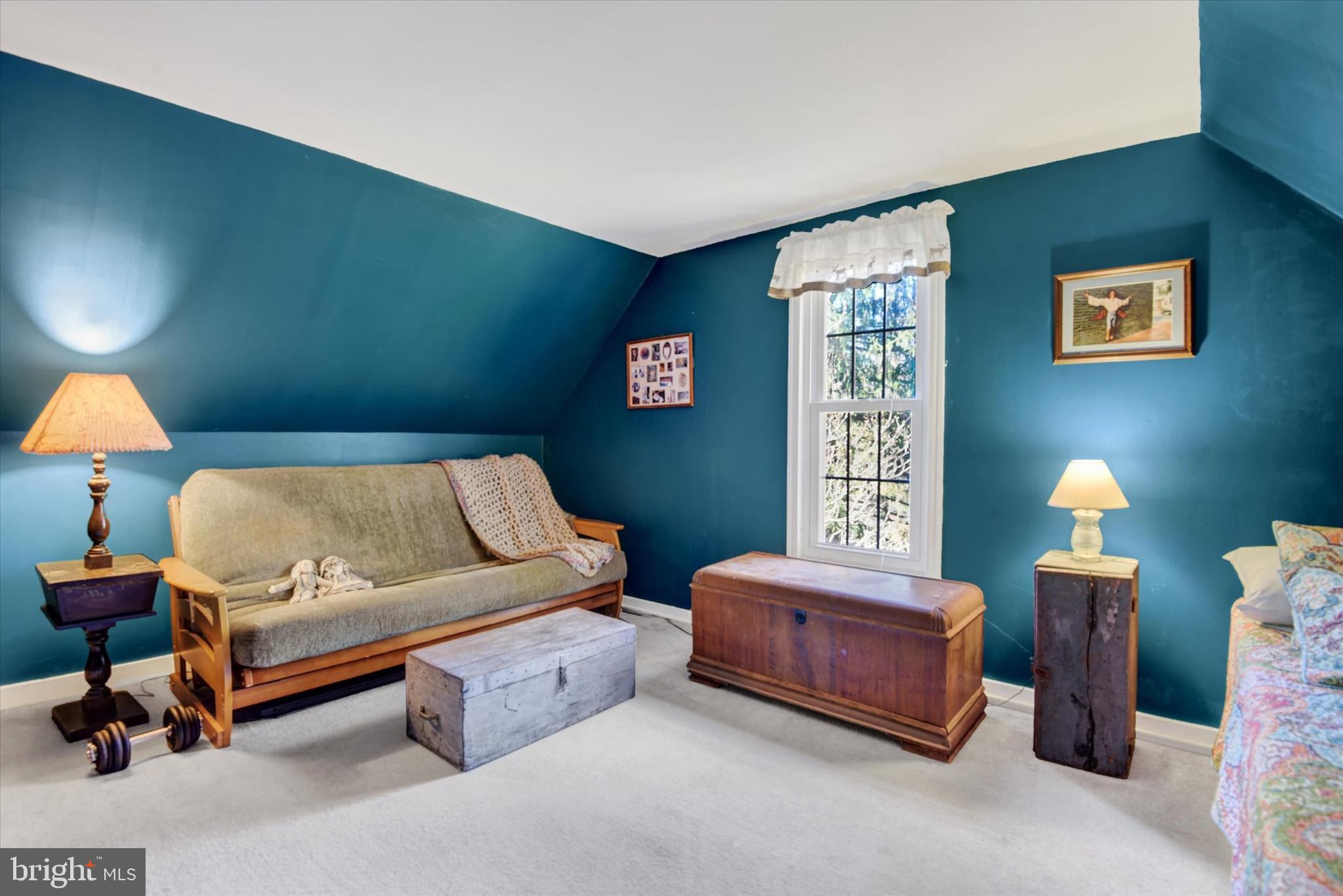 6739 South Clifton Road Frederick, MD 21703 - Photo 37 of 49 a living room with furniture and a lamp