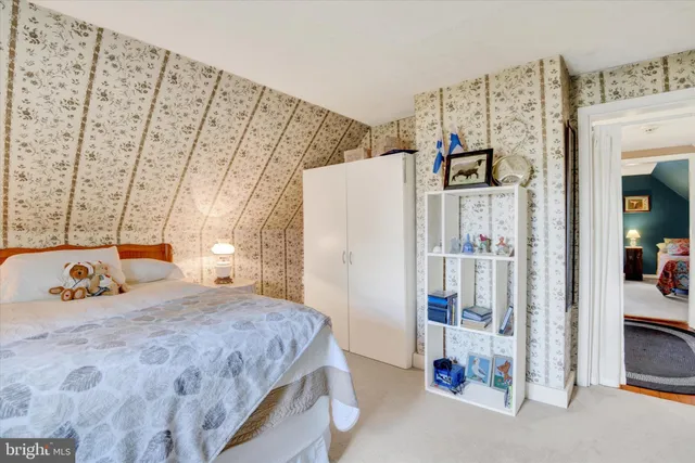 a bedroom with a bed and a refrigerator
