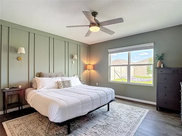 a bedroom with a large bed and a window