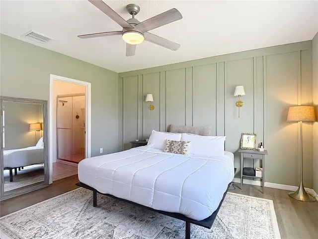 a bedroom with a bed a table and chair