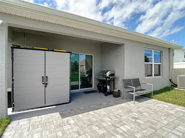 a view of a bedroom with gym equipment and floor to ceiling window