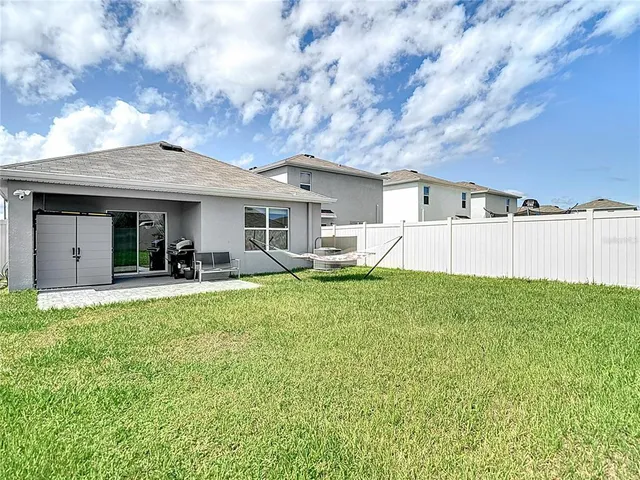 a view of a house with backyard porch and sitting area
