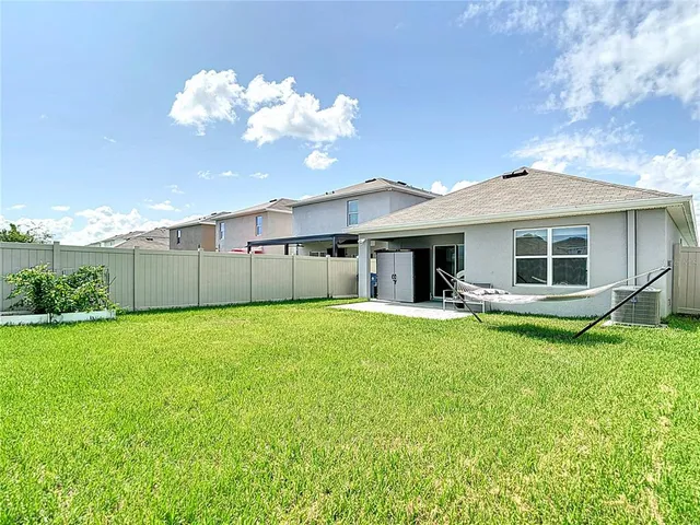 a view of a house with a backyard