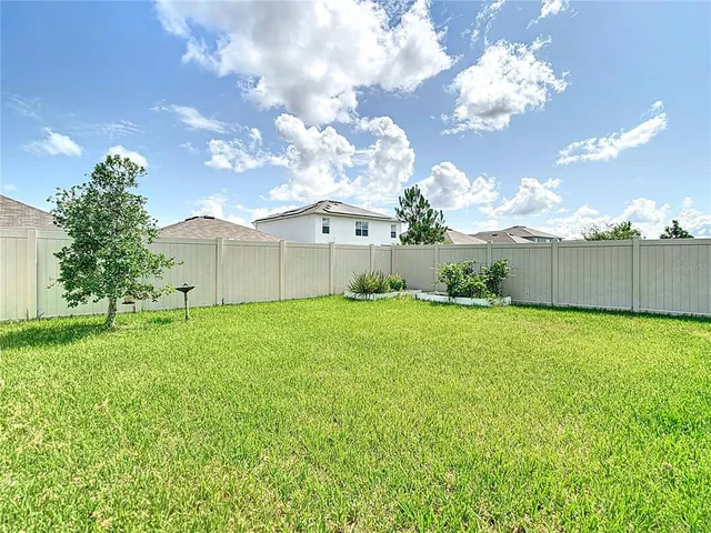 a backyard of a house with lots of green space