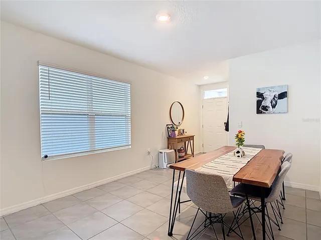 a dining room with a table and chairs