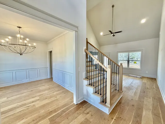 a large white kitchen with a large window appliances and cabinets