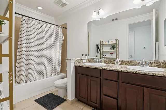 a bathroom with a double vanity sink toilet and a mirror