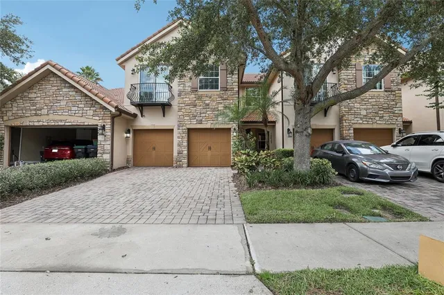 a view of a house with a garden and pathway