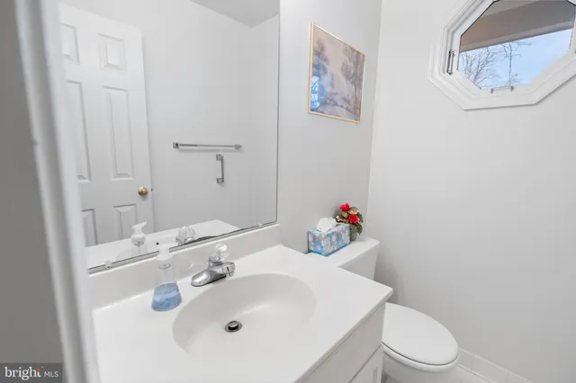 a bathroom with a sink mirror and toilet