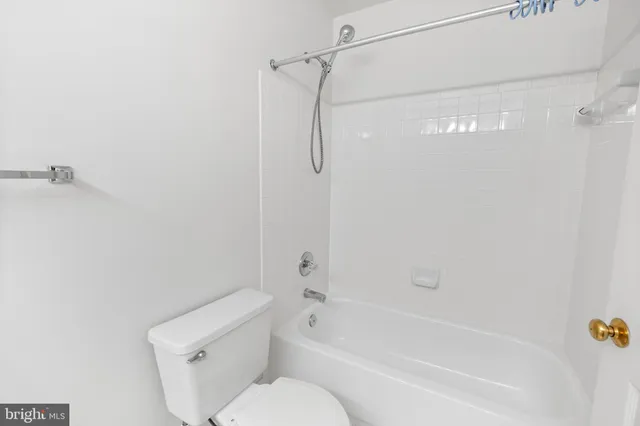 a bathroom with a shower and a toilet