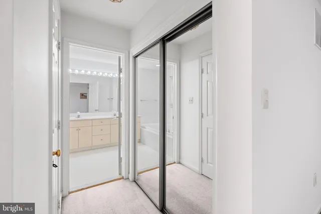 a bathroom with a glass shower door and a mirror