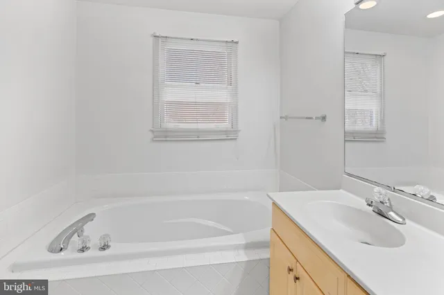 a white bath tub sitting next to a white sink