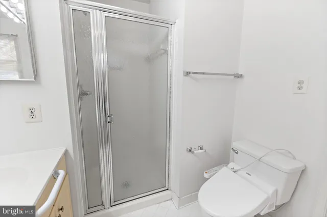 a bathroom with a toilet and a shower