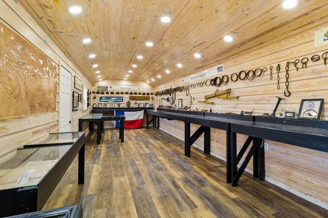 a view of a bedroom with wooden floor and a window
