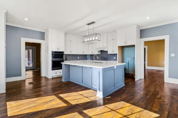 a view of a room with furniture and floor to ceiling window