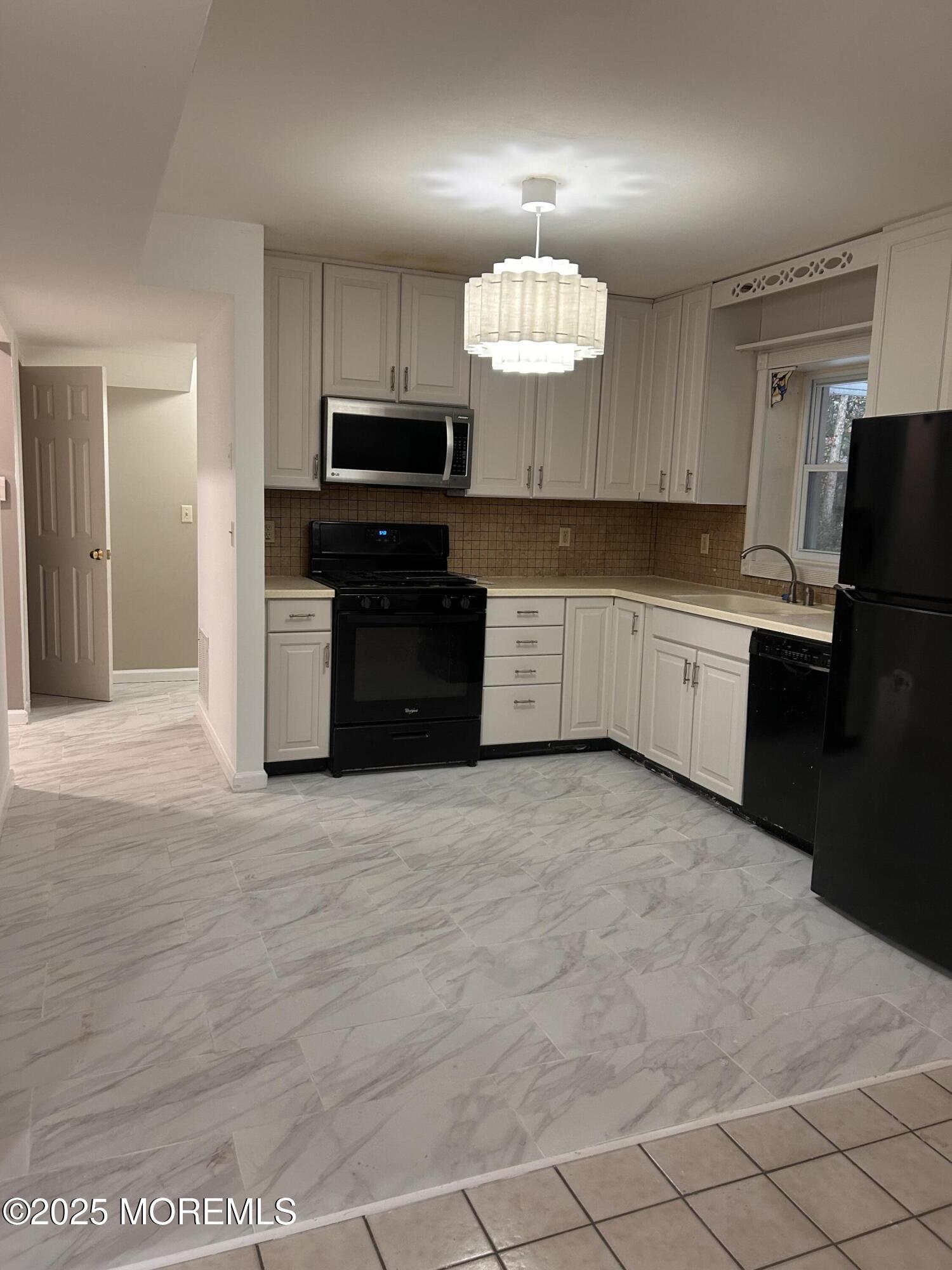 823 Bowman Road Jackson, NJ 08527 - Photo 21 of 27 a large kitchen with cabinets and stainless steel appliances