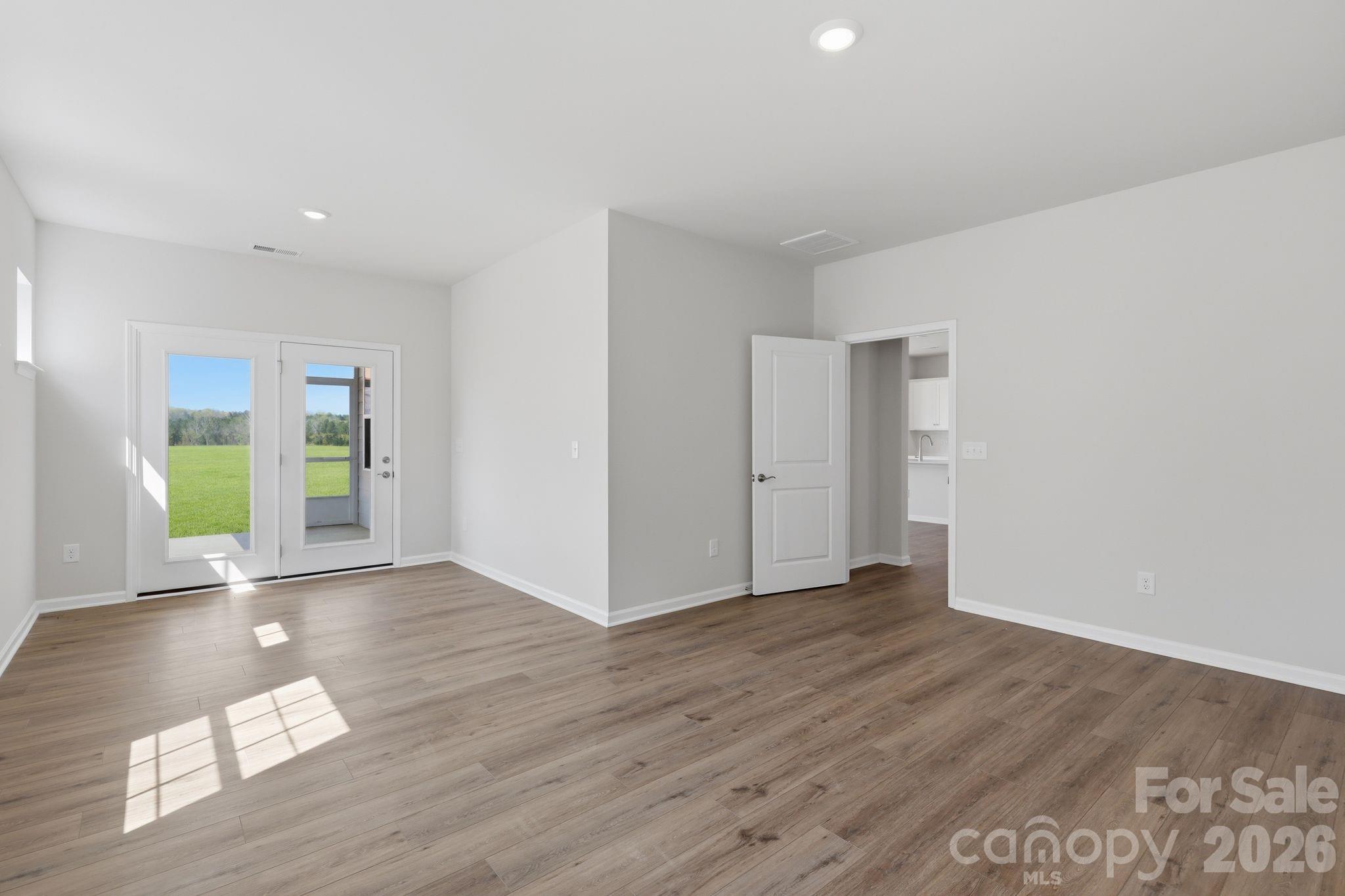 5475 Redbud Road, Unit 57 Lancaster, SC 29720 - Photo 11 of 30 a view of an empty room with wooden floor and a window