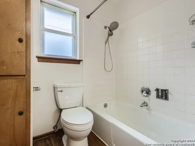 a bathroom with a toilet and a bathtub
