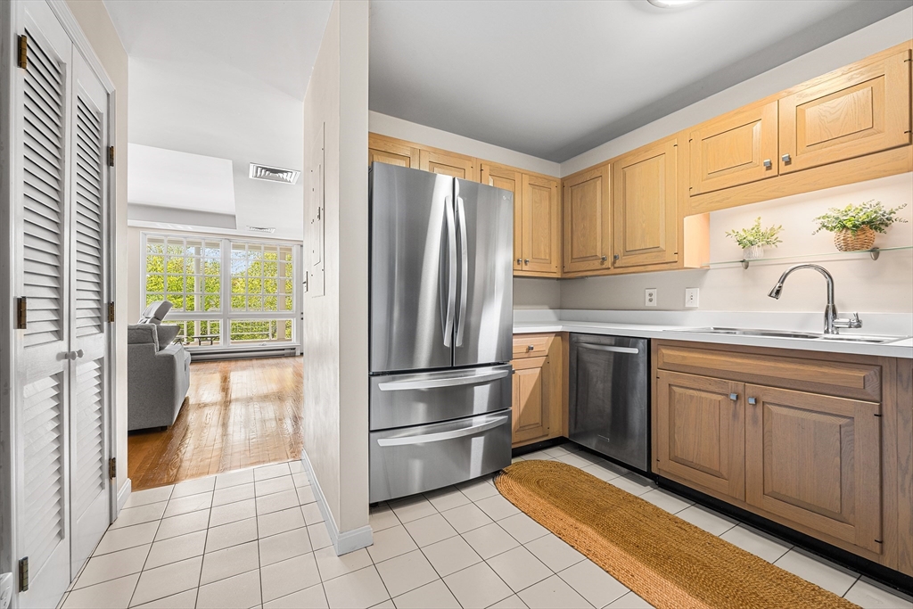 63 Garden Road, Unit C5 Wellesley, MA 02481 - Photo 12 of 30 a kitchen with granite countertop a refrigerator and a sink