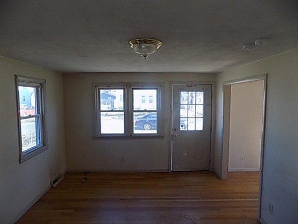 86 Wallace Street Springfield, MA 01119 - Photo 5 of 21 an empty room with wooden floor and windows