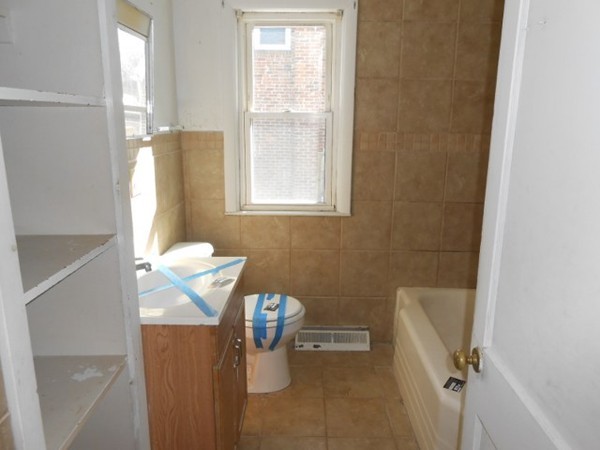 86 Wallace Street Springfield, MA 01119 - Photo 9 of 21 a bathroom with a granite countertop sink a toilet and a shower