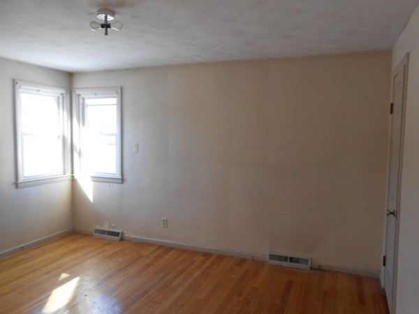 86 Wallace Street Springfield, MA 01119 - Photo 10 of 21 an empty room with wooden floor and windows