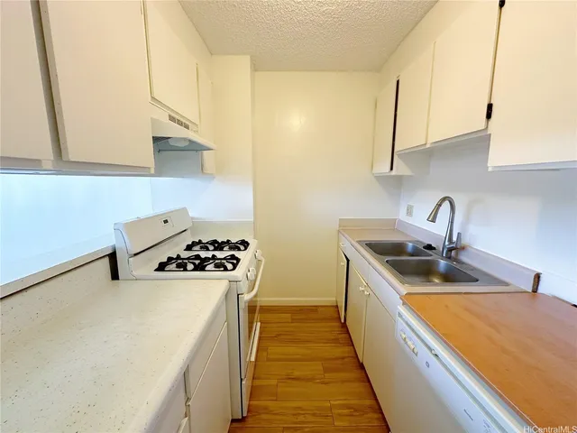 a kitchen with sink a stove and refrigerator