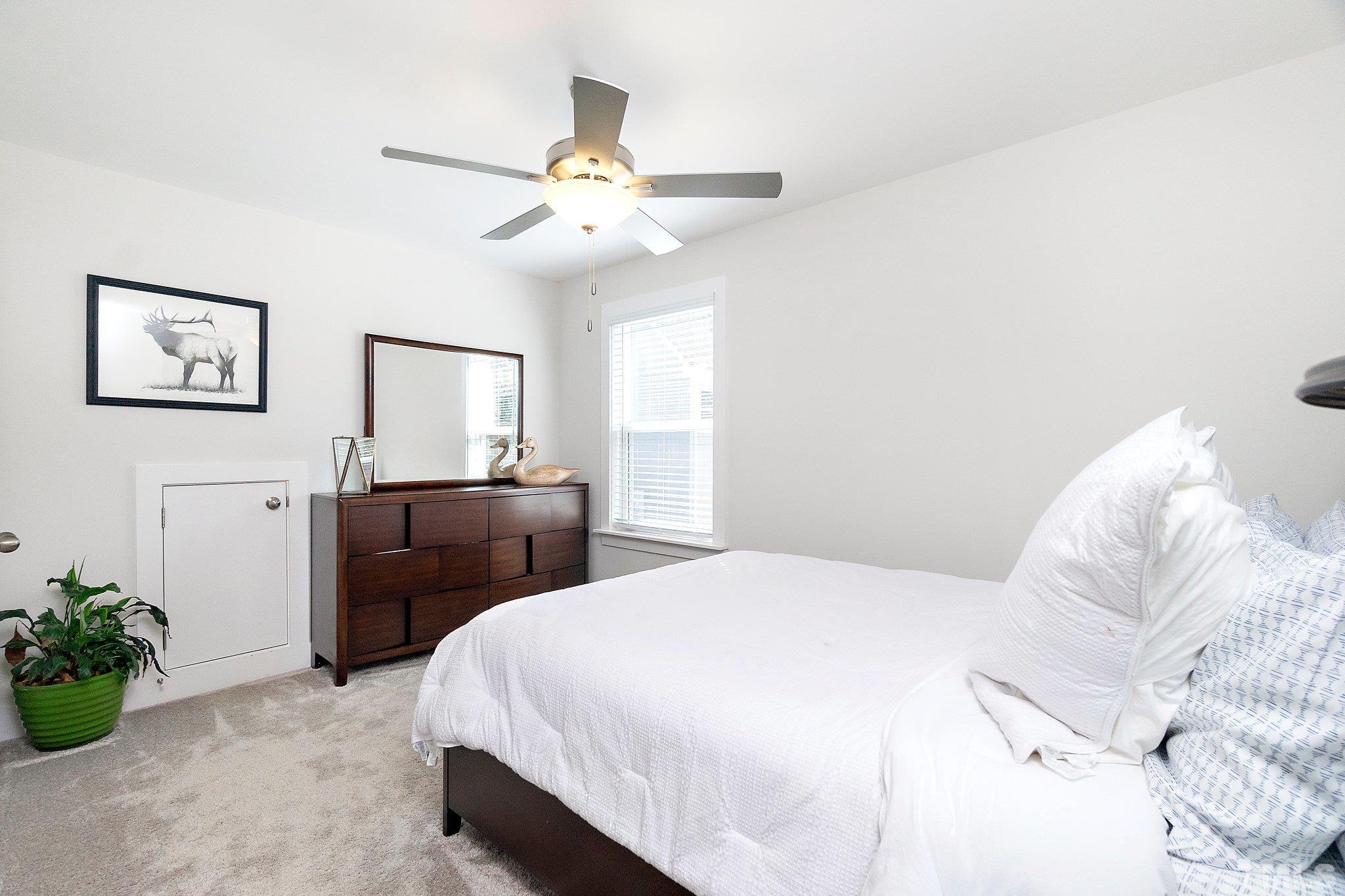 1510 Concord Street Durham, NC 27707 - Photo 14 of 17 a bedroom with a bed and a chandelier
