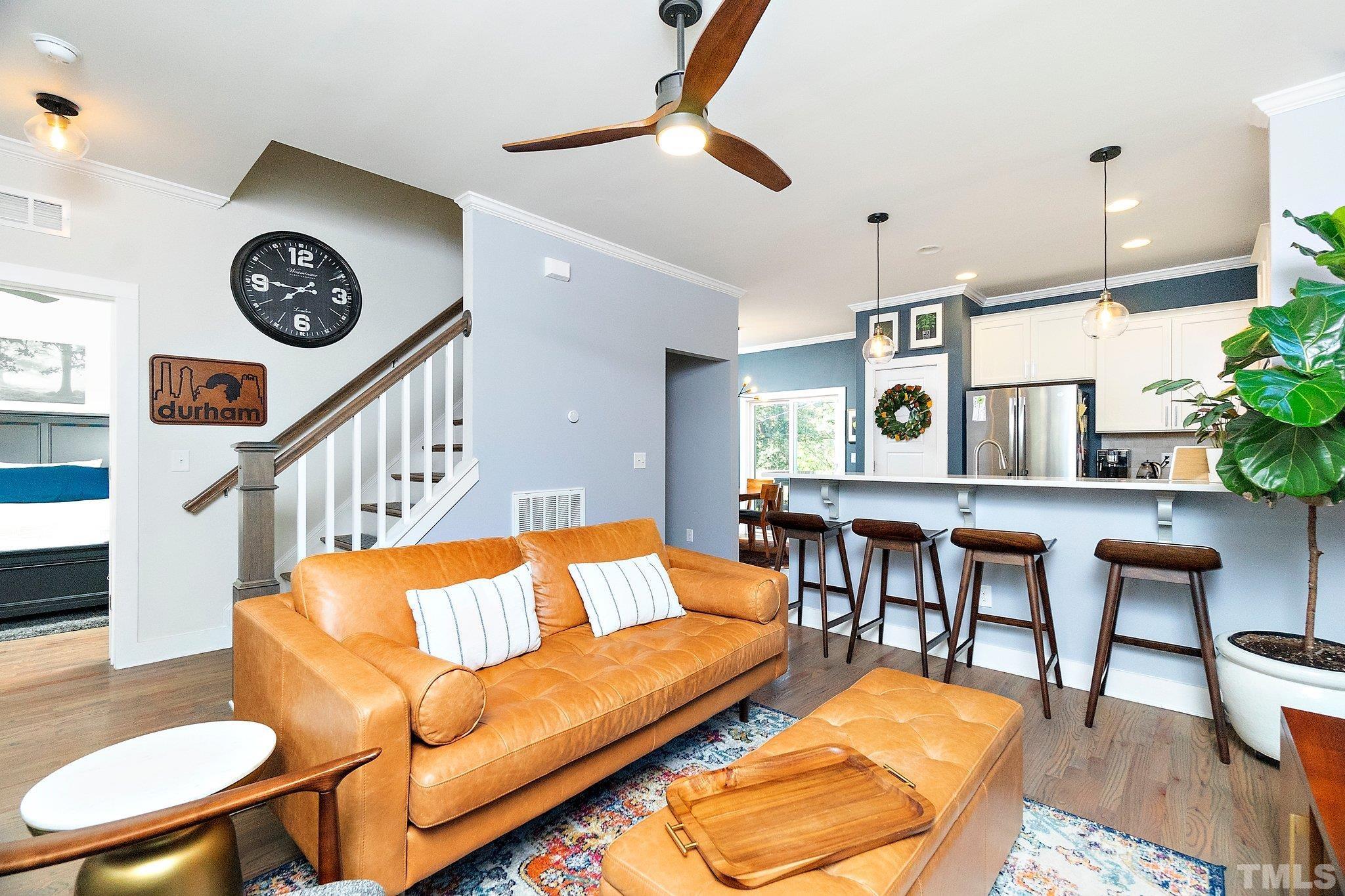 1510 Concord Street Durham, NC 27707 - Photo 4 of 17 a living room with furniture a clock and a rug