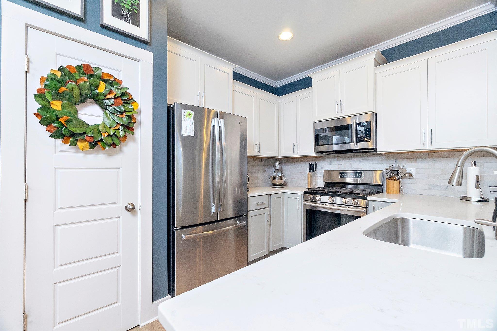 1510 Concord Street Durham, NC 27707 - Photo 6 of 17 a kitchen with stainless steel appliances a refrigerator sink and microwave