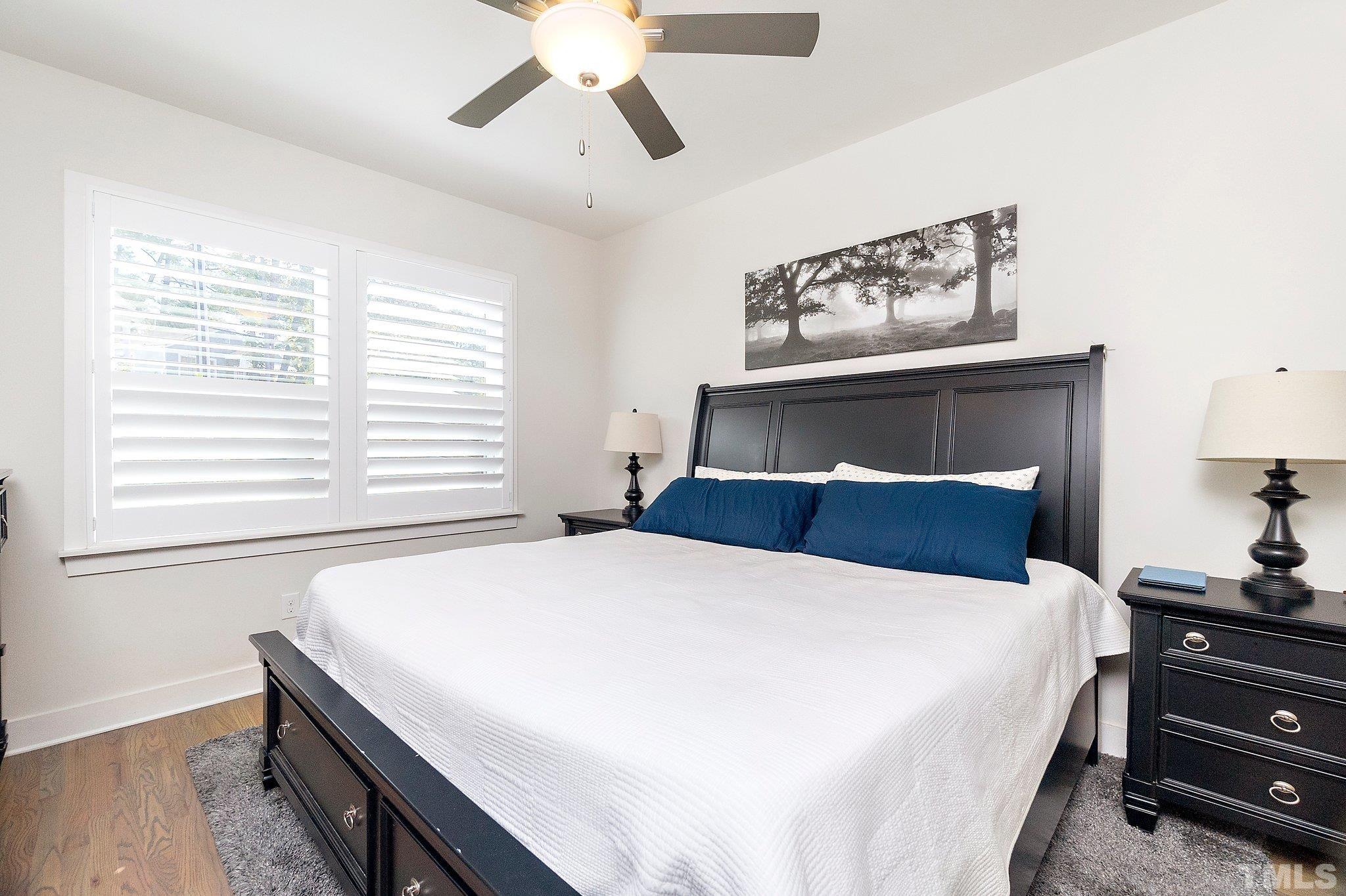 1510 Concord Street Durham, NC 27707 - Photo 8 of 17 a bedroom with a large bed and a chandelier