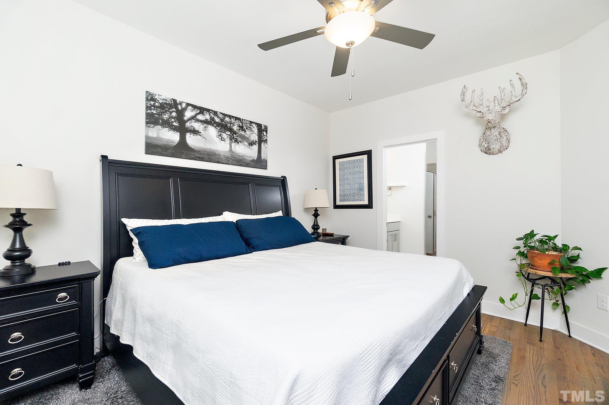 1510 Concord Street Durham, NC 27707 - Photo 9 of 17 a bedroom with a bed and a chandelier