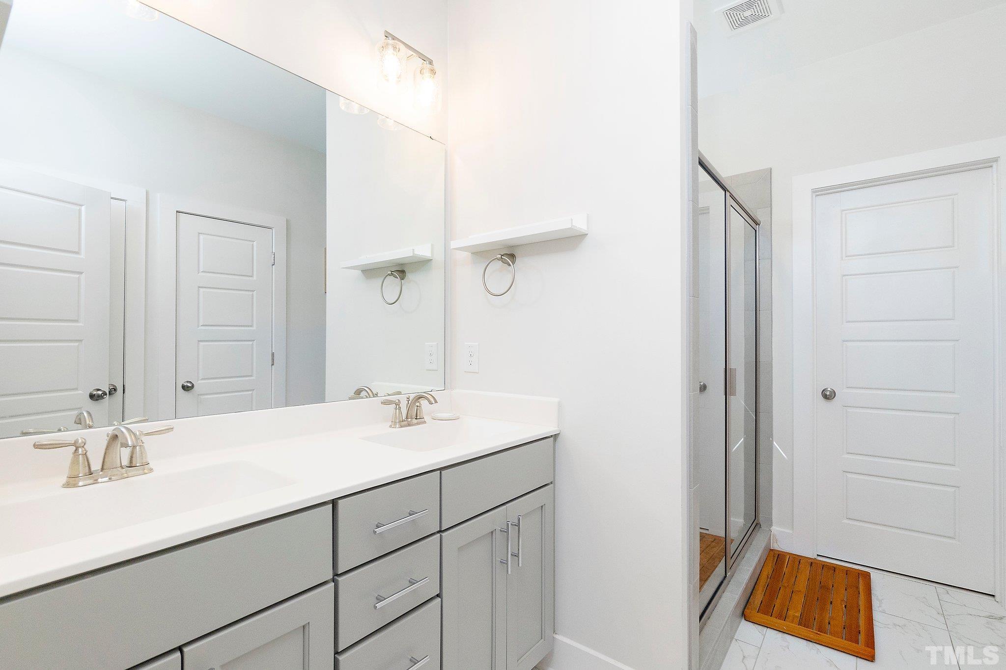 1510 Concord Street Durham, NC 27707 - Photo 10 of 17 a bathroom with a sink and a mirror