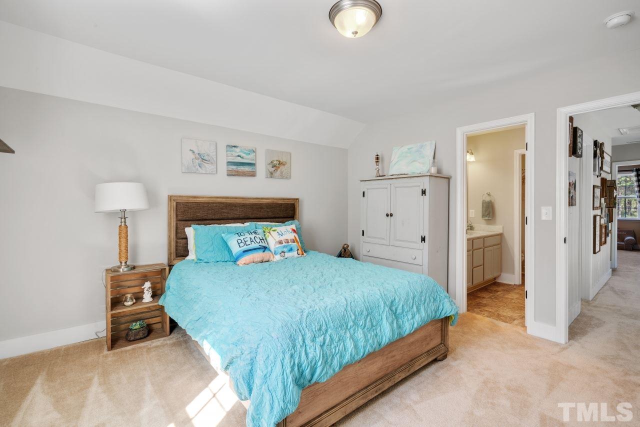 7255 Highway 231 Middlesex, NC 27557 - Photo 17 of 27 a bedroom with a bed and a lamp