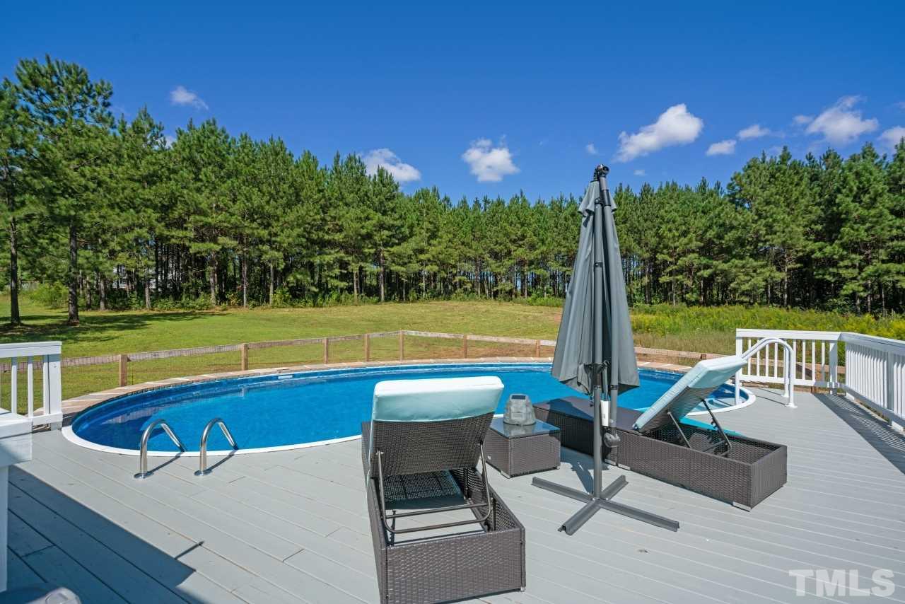 7255 Highway 231 Middlesex, NC 27557 - Photo 25 of 27 a view of a swimming pool with a patio and a yard