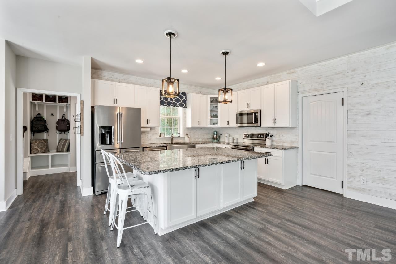 7255 Highway 231 Middlesex, NC 27557 - Photo 10 of 27 a kitchen with stainless steel appliances granite countertop a refrigerator a stove and a wooden floors