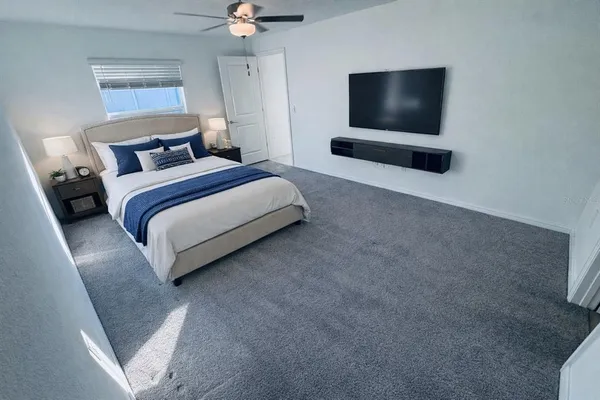 a bedroom with a bed and a flat screen tv