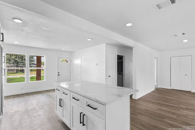 a kitchen with granite countertop a stove and a sink