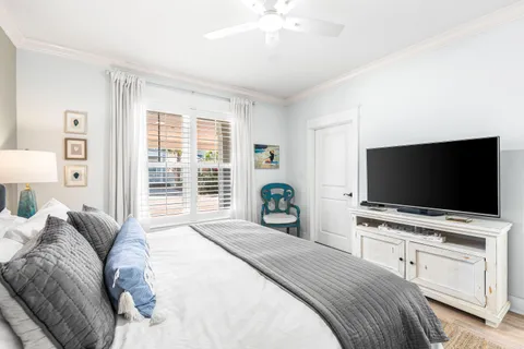 a bedroom with a bed and a flat screen tv