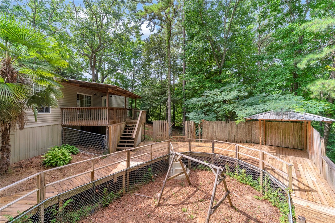 383 Rocky Knoll Road Walhalla, SC 29691 - Photo 46 of 50 A spacious wooden deck with a covered area provides an ideal spot for outdoor enjoyment.