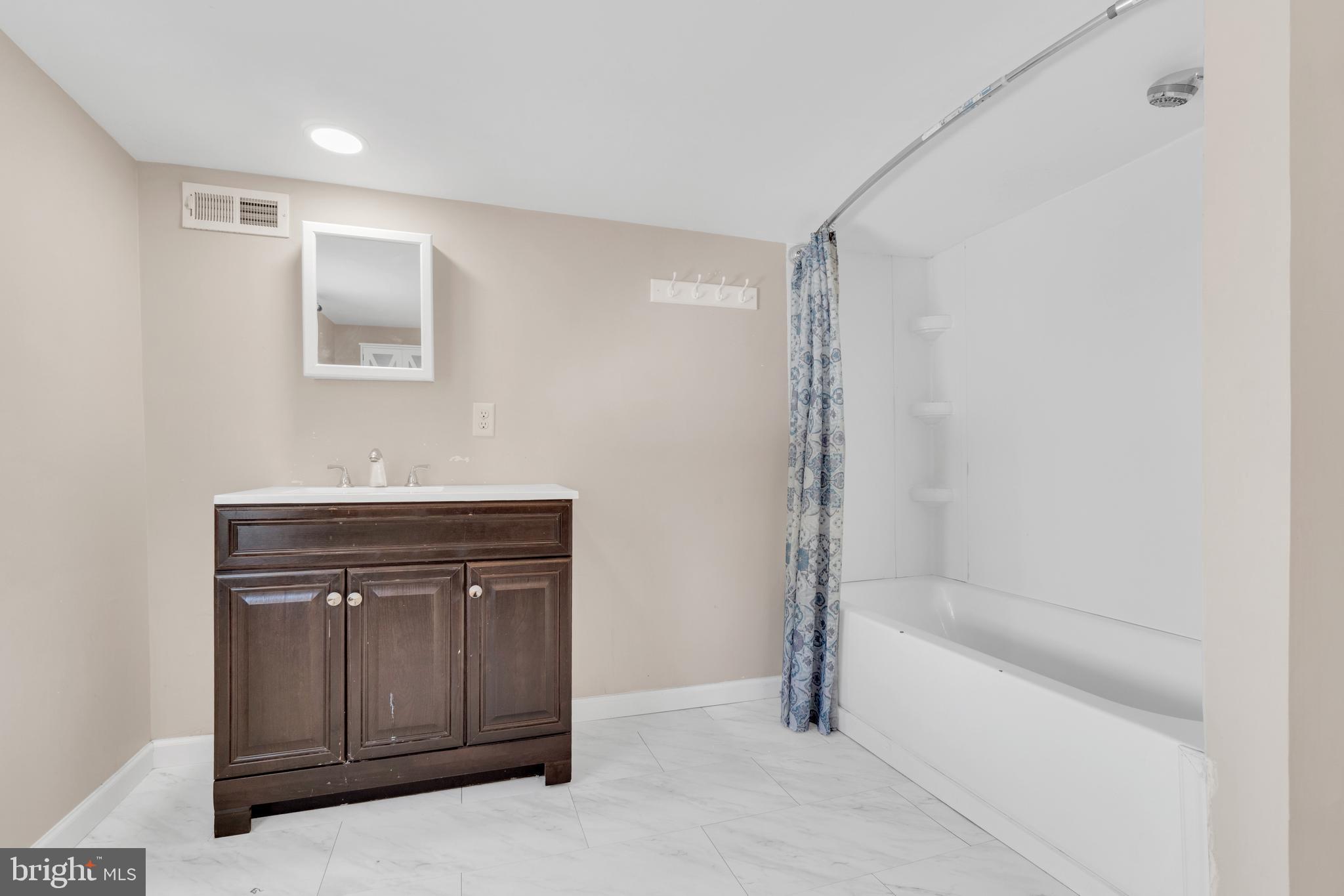 19 Pleasant Street Southampton, NJ 08088 - Photo 13 of 23 a bathroom with a tub shower and sink