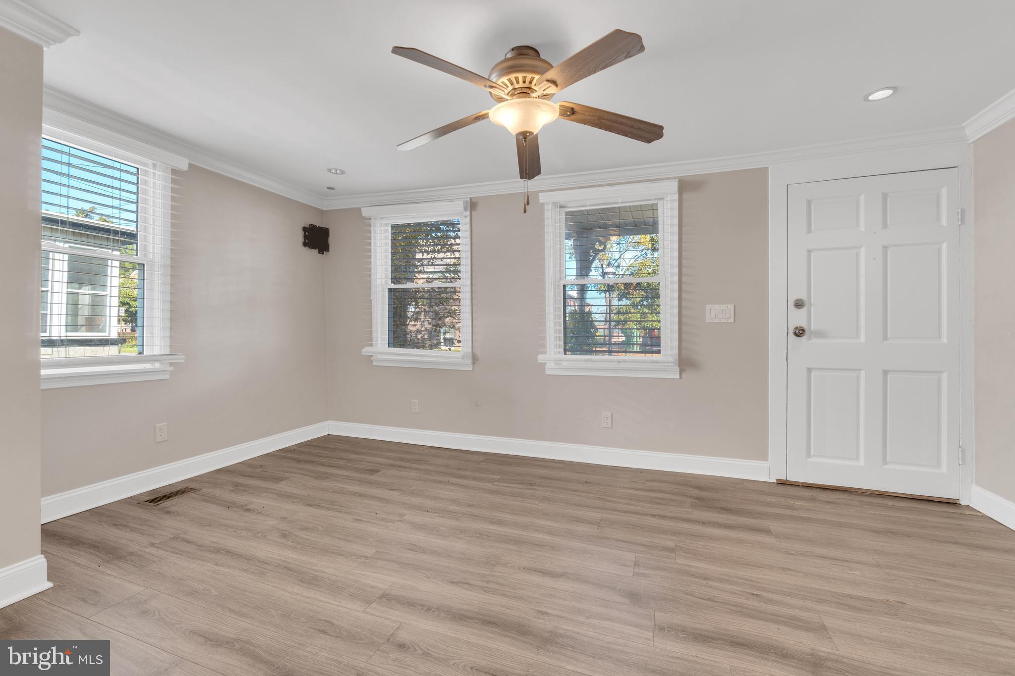19 Pleasant Street Southampton, NJ 08088 - Photo 6 of 23 a view of an empty room with window and wooden floor