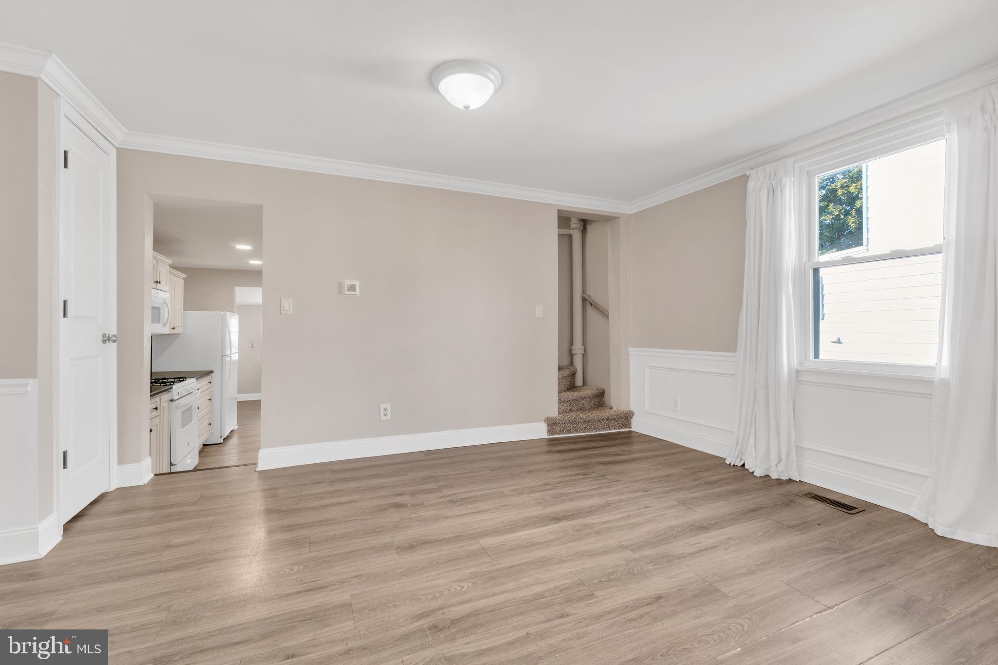 19 Pleasant Street Southampton, NJ 08088 - Photo 7 of 23 a view of an empty room with wooden floor and a window