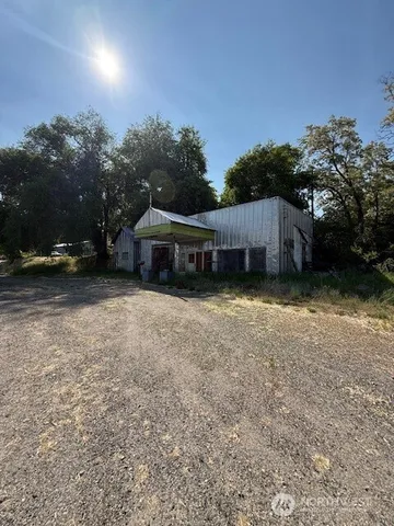 a view of a house with a yard and covered with green space