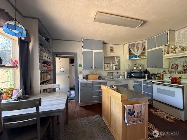 a kitchen with cabinets and window