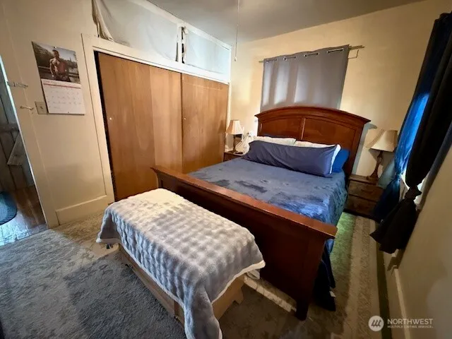 a bedroom with a bed and a mirror
