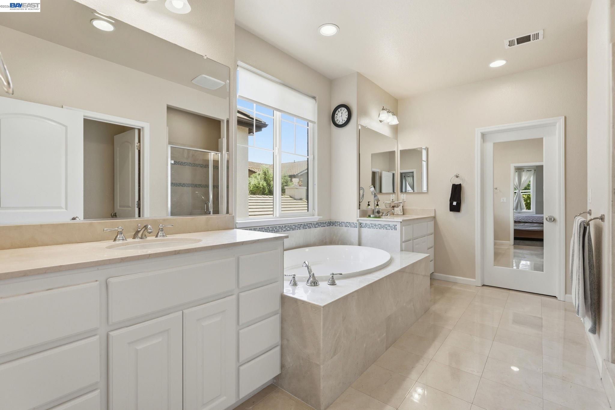 5029 Queensbury Way San Ramon, CA 94582 - Photo 28 of 58 a spacious bathroom with a sink double vanity granite tub shower and a mirror