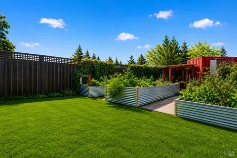 a green field with lots of trees in the background